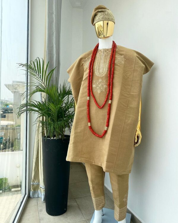 Aso-Oke Dashiki, with a floral and ancient style shaped embroidery design, hand woven Yoruba hat, an extra length red and gold coral bead.
